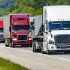A,Solid,Line,Of,Eighteen-wheelers,Barrel,Down,An,Interstate,Highway